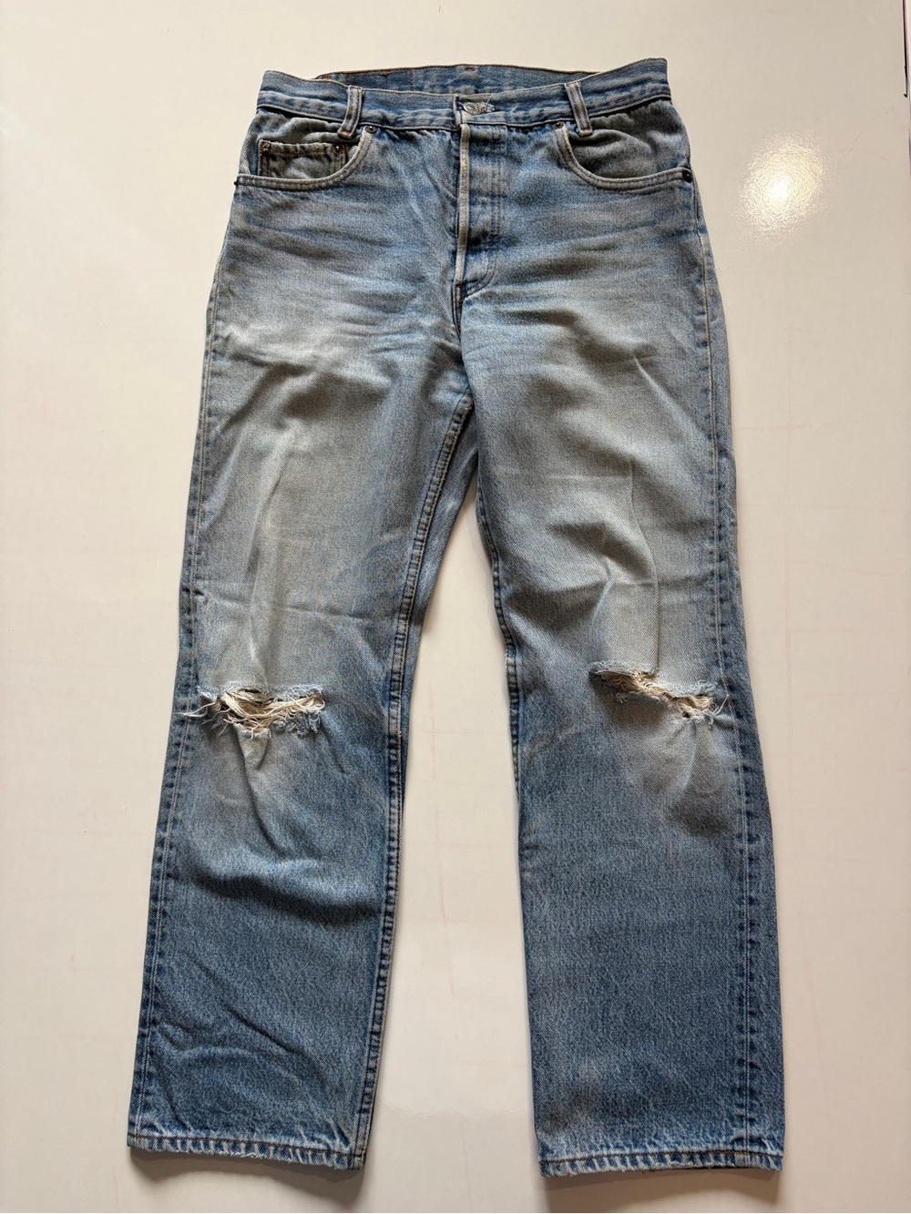 vintage light-wash Levi's 501 jeans button fly distressed knees size medium